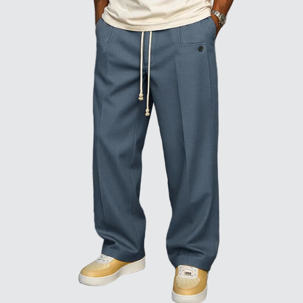 Person wearing blue pants with a drawstring and beige shoes